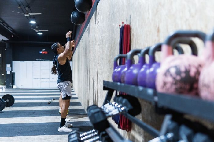 Athletes training with medicine balls in a gym